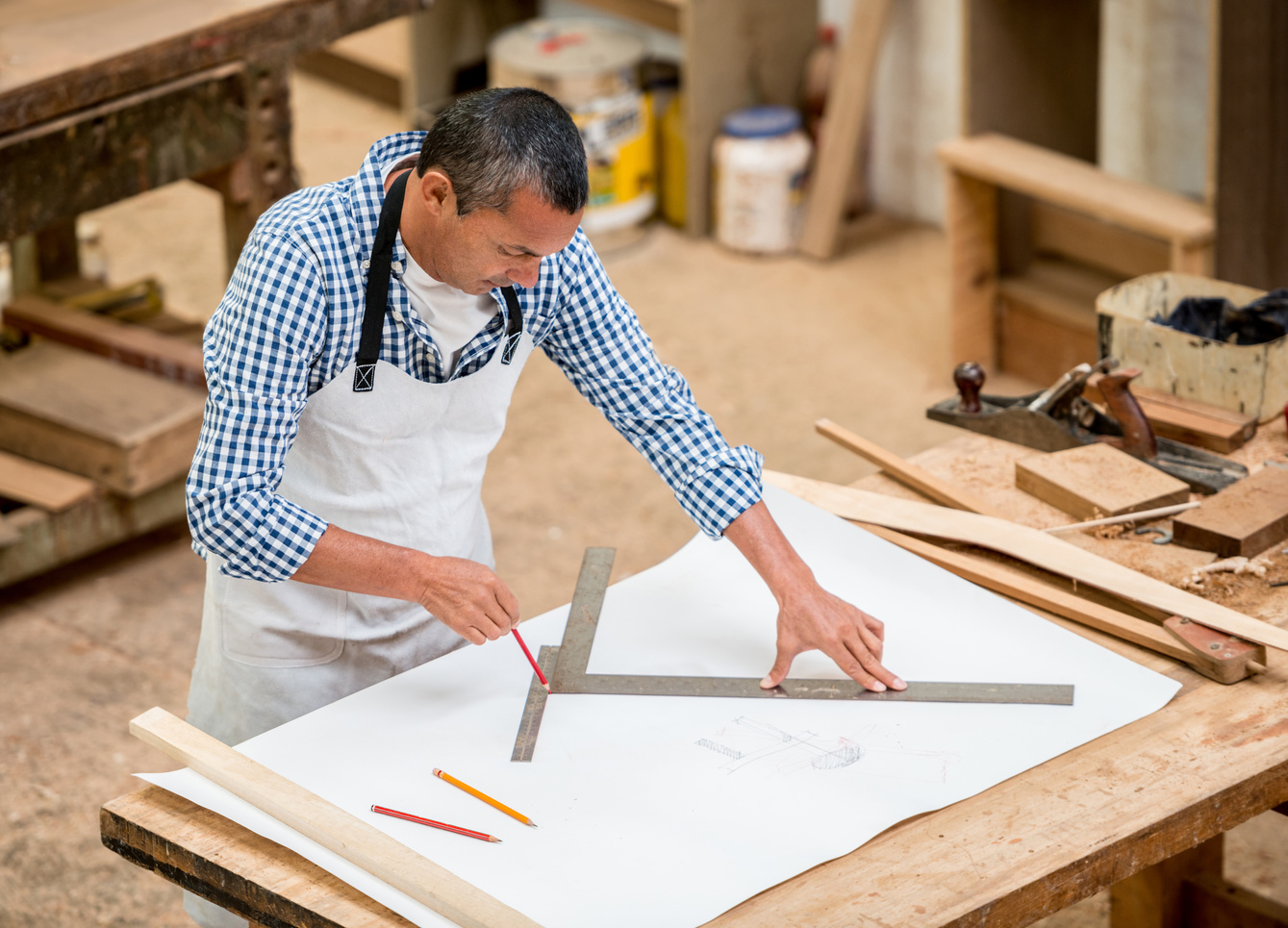 Carpenter working on furniture designs